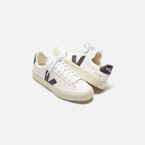 White and black sneakers made from ChromeFree leather with organic cotton laces and recycled materials.