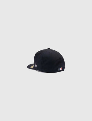Navy New Era Fence Braves fitted hat with raised embroidered logo and fence graphics side view